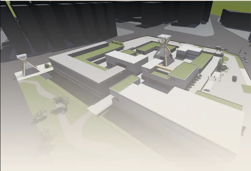 Aerial view of a physical model showing clustered volumes with green roofs around a central radial structure
