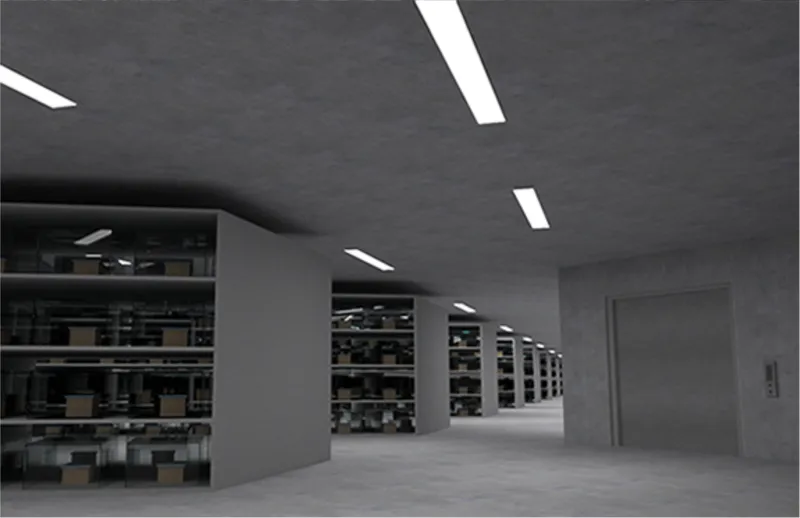 Interior corridor with concrete columns and recessed ceiling lighting running past storage shelving units