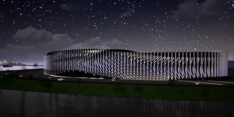 Long view of the illuminated vertical fin facade reflected in a still water body under a starry night sky