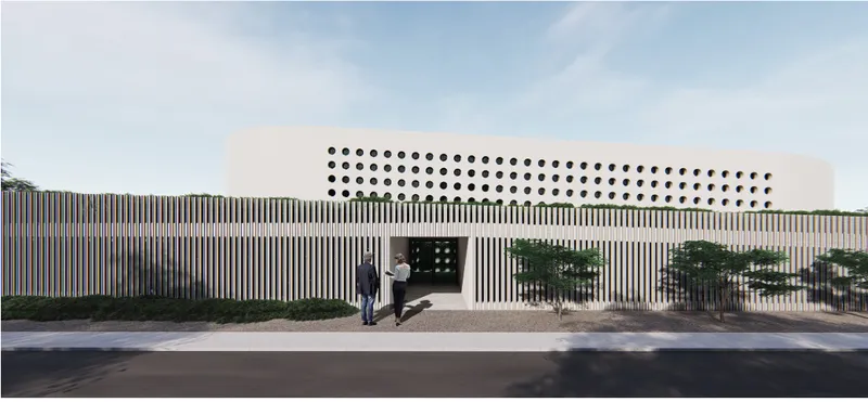 Street facade with vertical timber slats and perforated upper volume as two figures approach the entrance