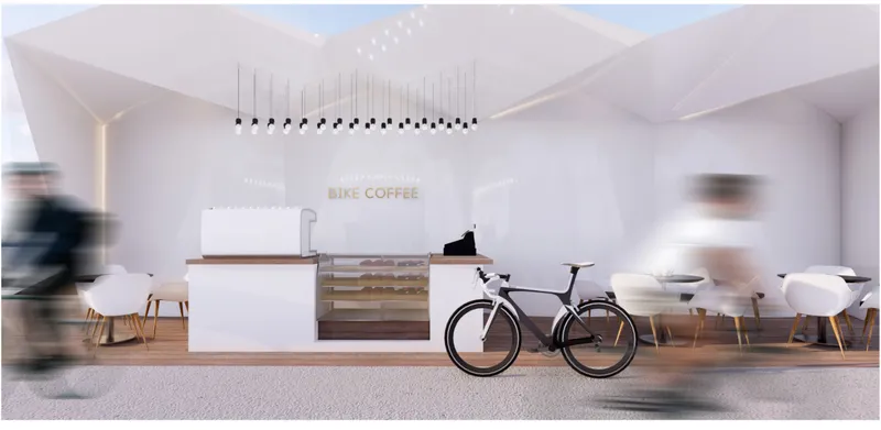 Interior view of cafe space with bicycle parked beside counter and pendant lights overhead