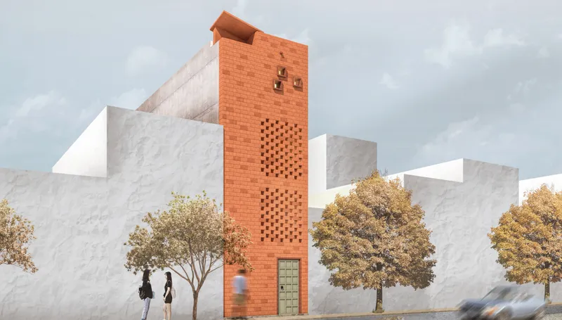Street view of the red brick tower with circular perforations flanked by pedestrians and autumn trees