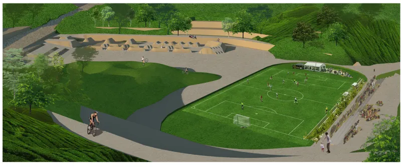 Aerial rendering of sports field and outdoor gathering pavilion with cyclist on curved path