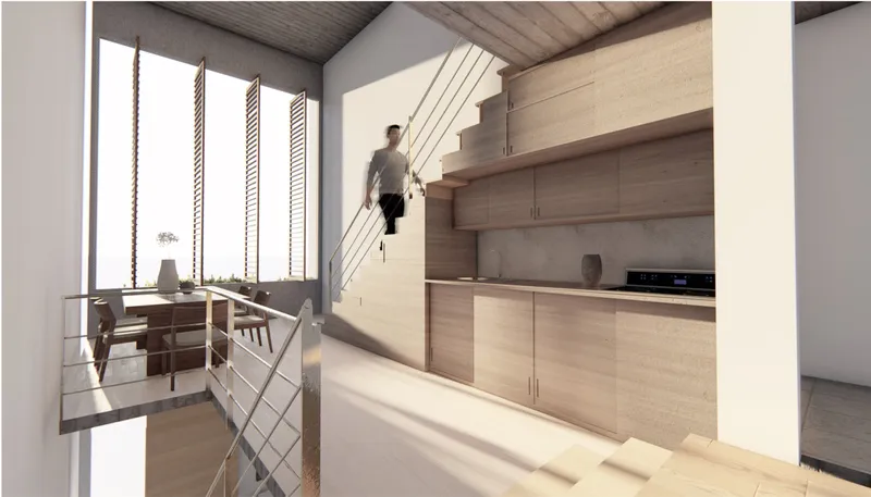 Kitchen with light wood cabinetry beneath a cantilevered staircase as a figure descends toward decorative screen wall