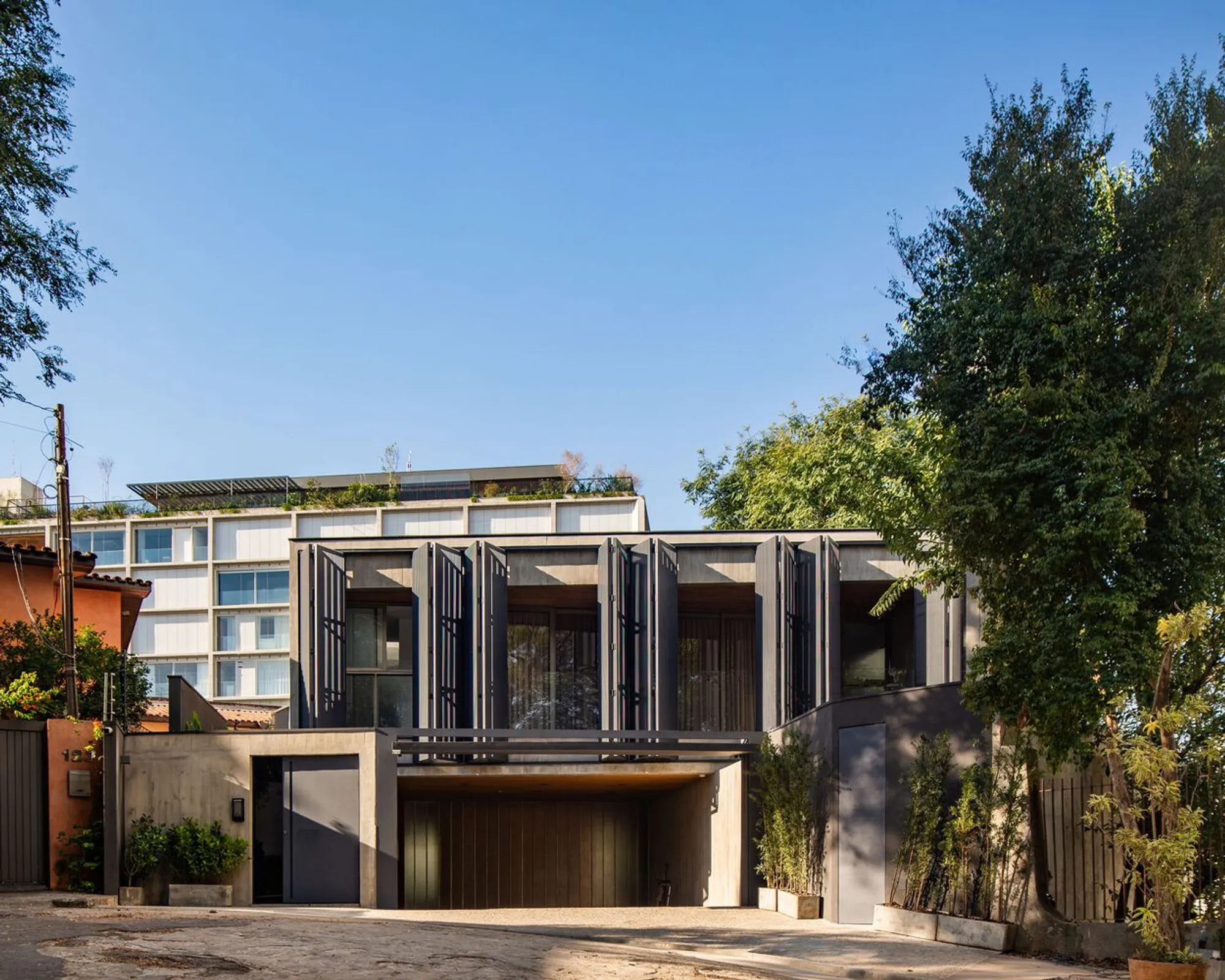 “Vila Madalena Residence by Gui Mattos: Brutalist Concrete Meets Warm Wooden Interiors in São Paulo”