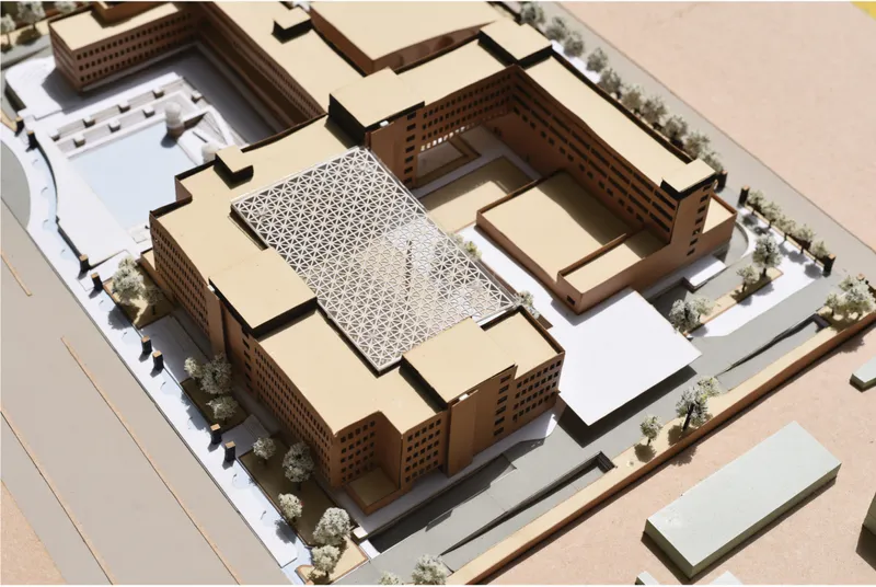 Aerial massing model highlighting central courtyard and jaali roof structure.