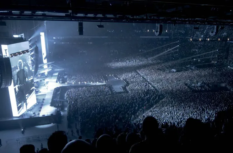 Interior view of the arena bowl filled with a crowd during a concert event