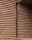 This architectural image showcases a close-up of a brick wall with a distinctive horizontal layering