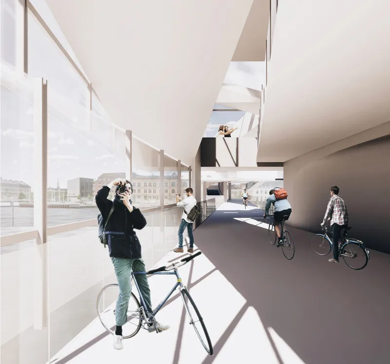 Dedicated cycling lane integrated within an open, light-filled architectural spine.