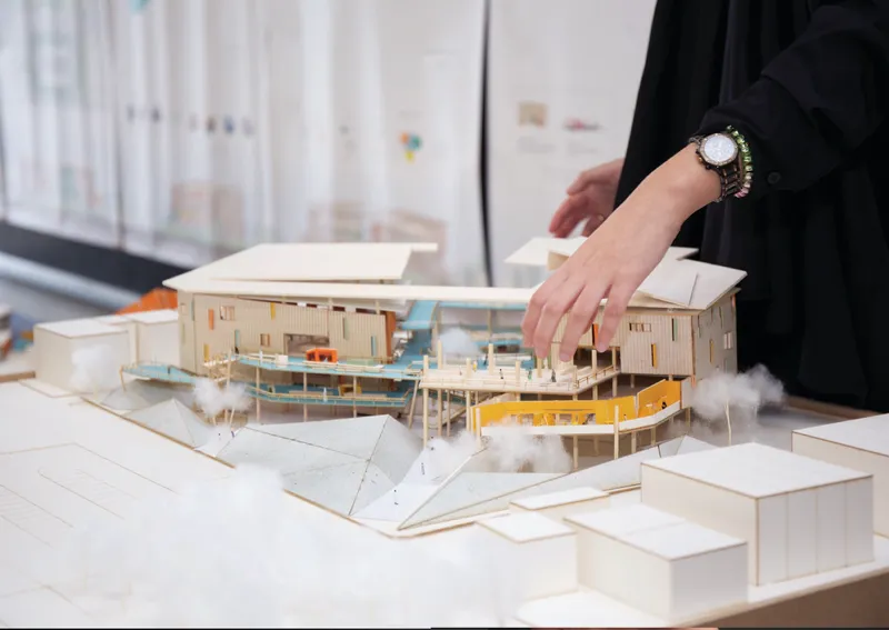 Physical study model illustrating the interconnected platforms, ramps, and open courtyards shaping the project’s spatial circulation.