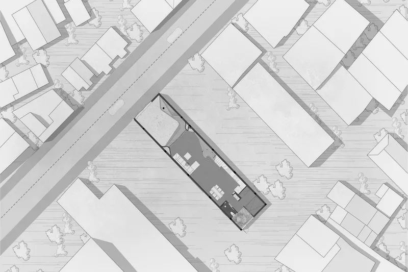Site plan drawing showing narrow lot positioned diagonally within surrounding street grid and buildings