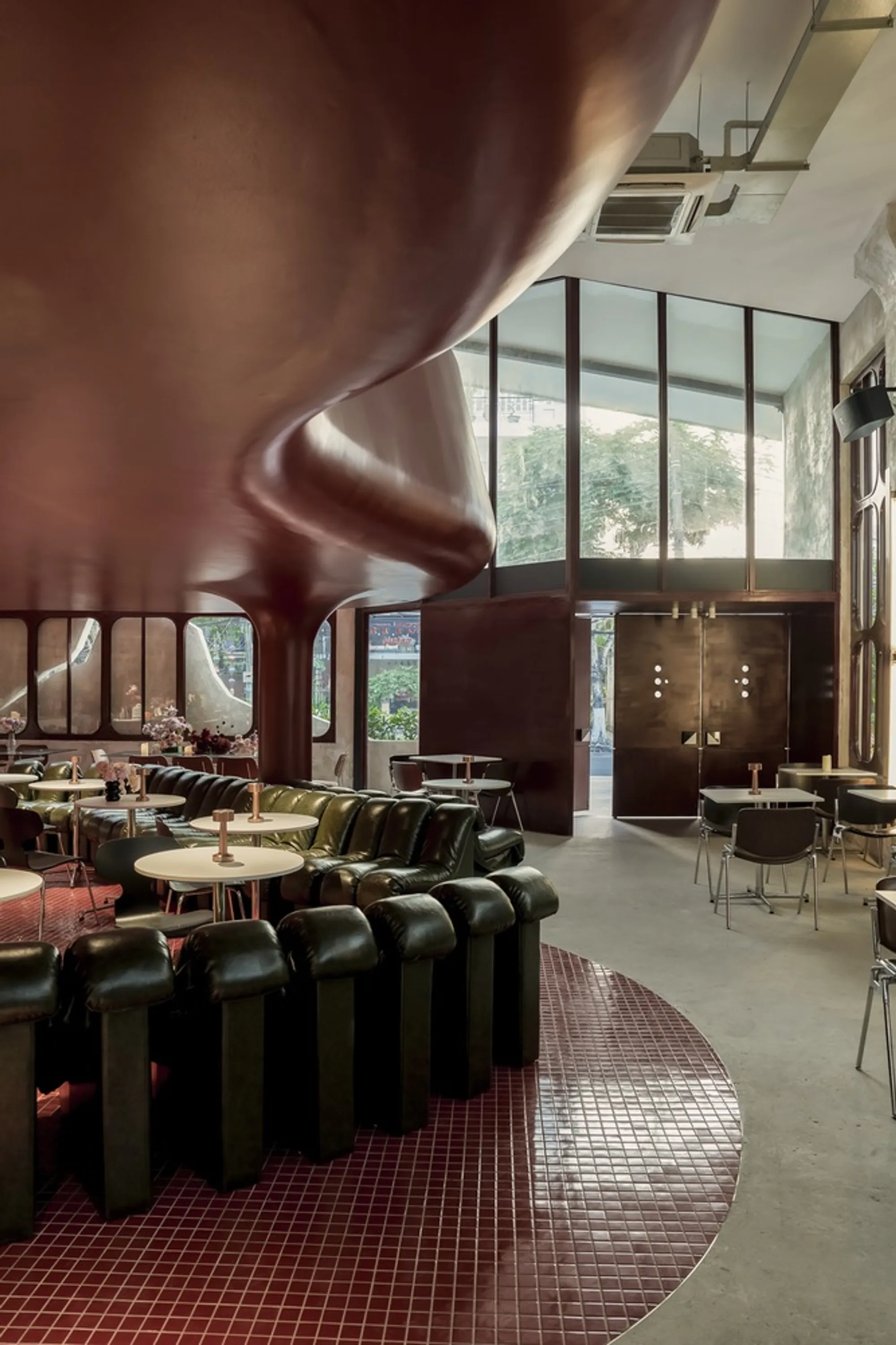 1.61 Design Workshop Wraps a 600-Square-Meter Café in Vietnam in Sculptural Burgundy Drama