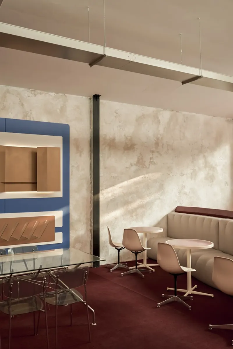 Seating nook with textured plaster wall, blue framed bar alcove and linear suspended lighting
