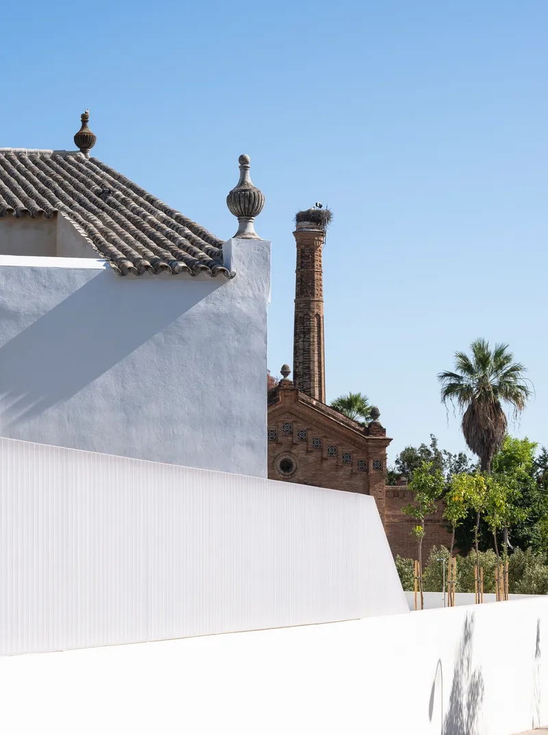 Original tiled roof and finials seen against the neighbouring brick chimney