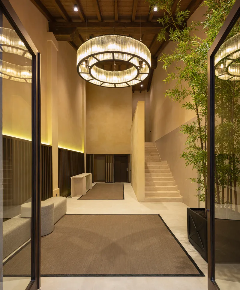 Reception lobby with circular crystal chandelier and bamboo planting