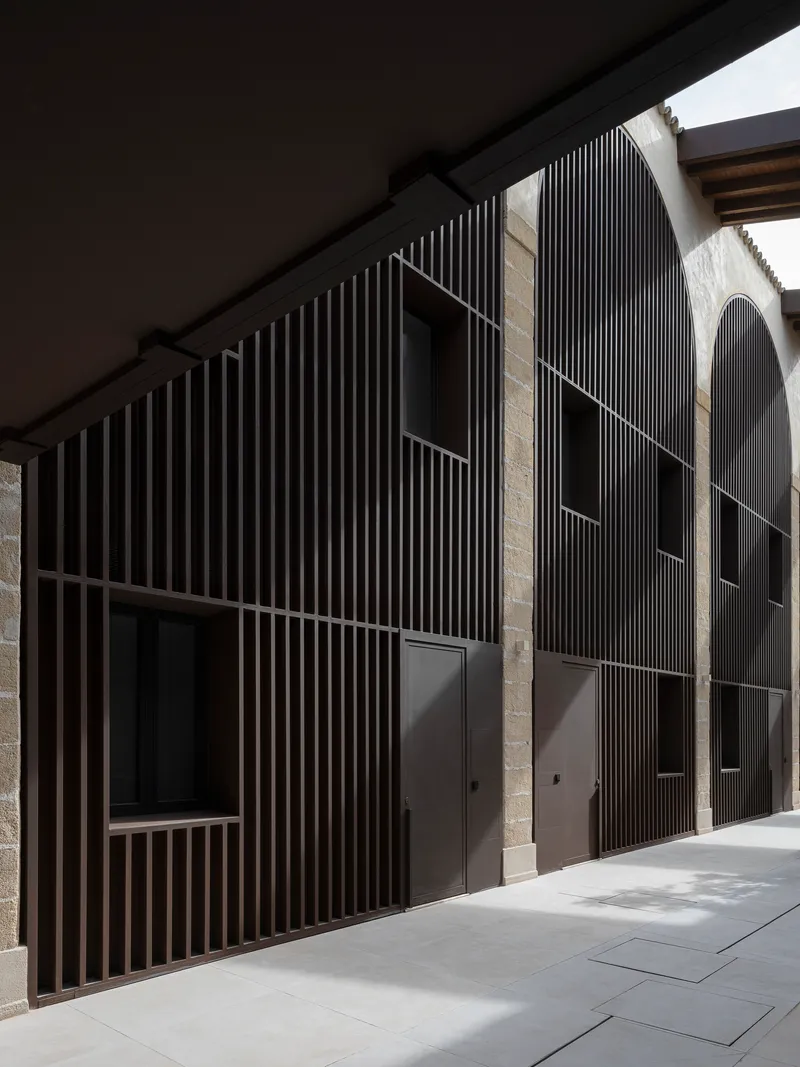 Detail of vertical timber slat screen against original sandstone walls