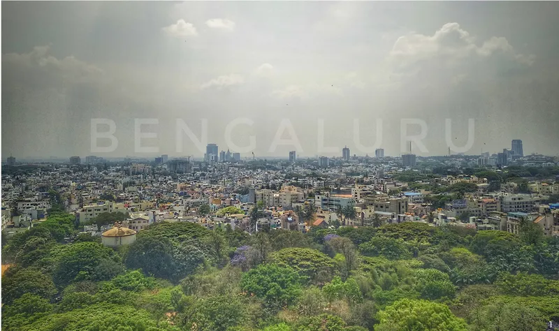 Bengaluru skyline viewed from the reclaimed quarry landscape, highlighting the urban context surrounding the White Rocks Quarry site.