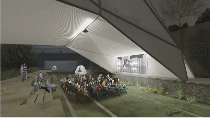 Outdoor cinema setup beneath the structure, activating the railway corridor as a cultural public space.
