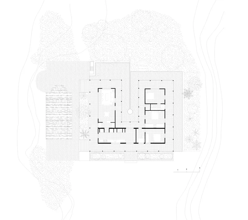 Floor plan drawing showing a square structure with central courtyard surrounded by landscape and trees