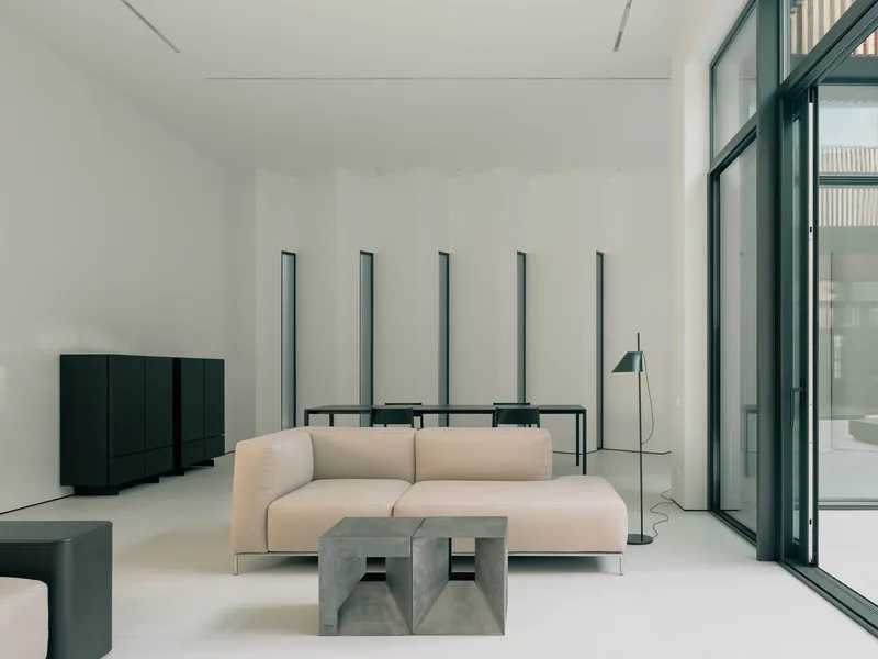 Interior living space with polished concrete floor and tall vertical window slits
