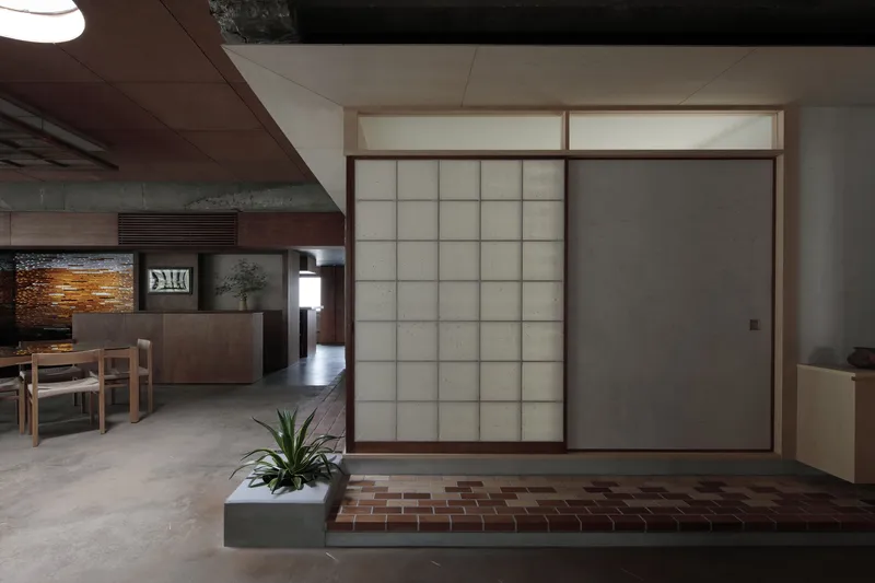 Closed translucent panel beside open shoji screen revealing the interior dining space beyond