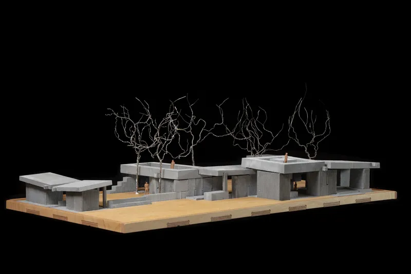 Physical model showing courtyard spaces between pavilions with corrugated walls and wire trees above