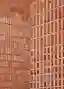 This architectural image showcases a brick facade with a unique design. The wall is constructed with