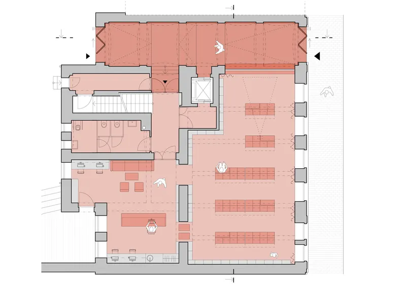 Floor plan drawing with spaces shaded in pink showing a gallery hall, staircase, and restroom facilities