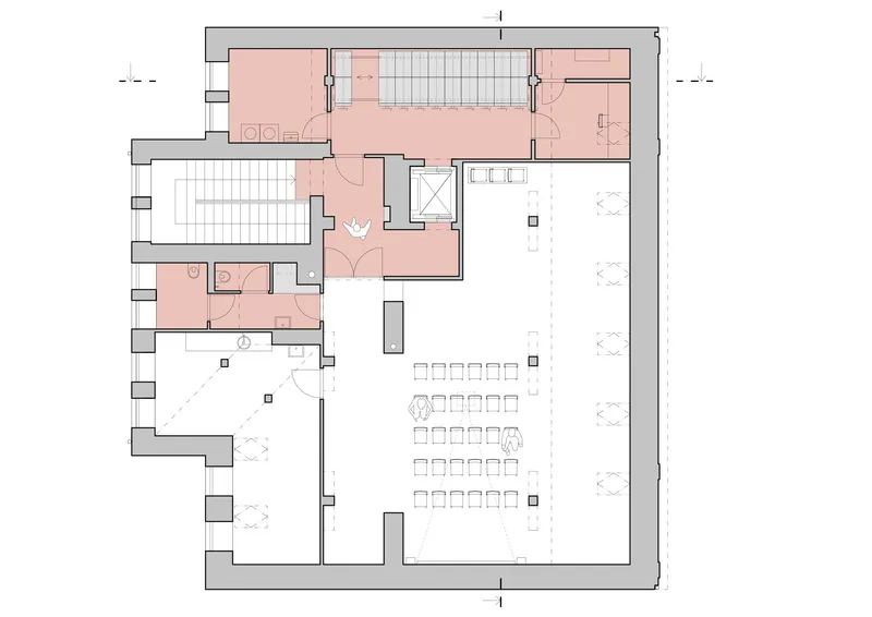 Floor plan showing a large open space with rows of seating and salmon-colored service areas along the perimeter