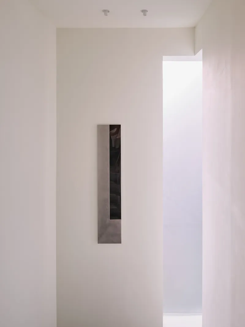Close-up of the inset mirrored panel on the upper-floor wall