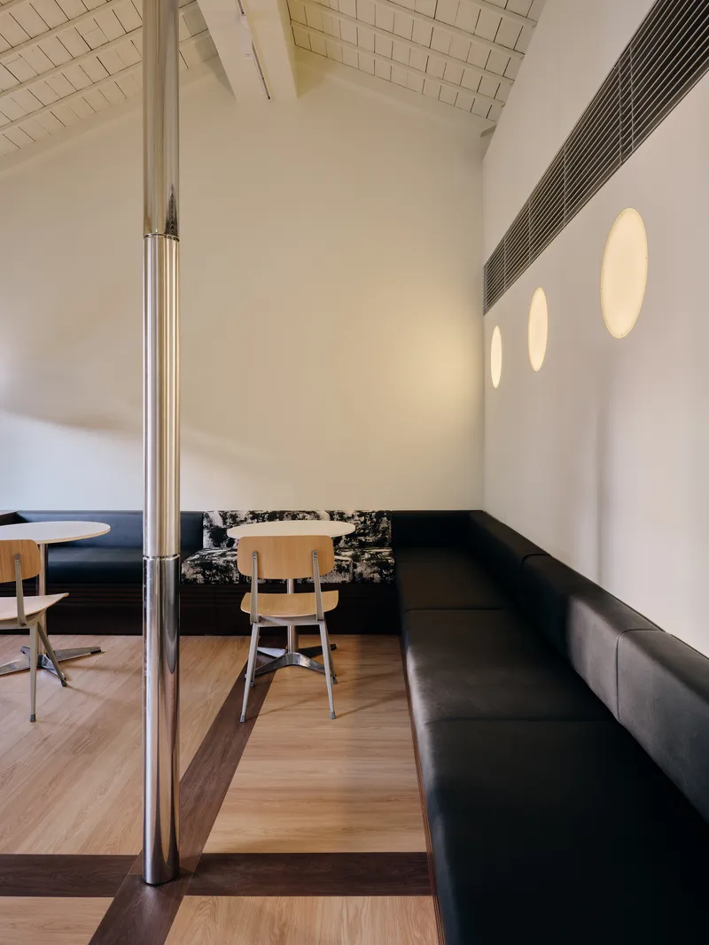 Long bench seating against a wall with three circular wall lights