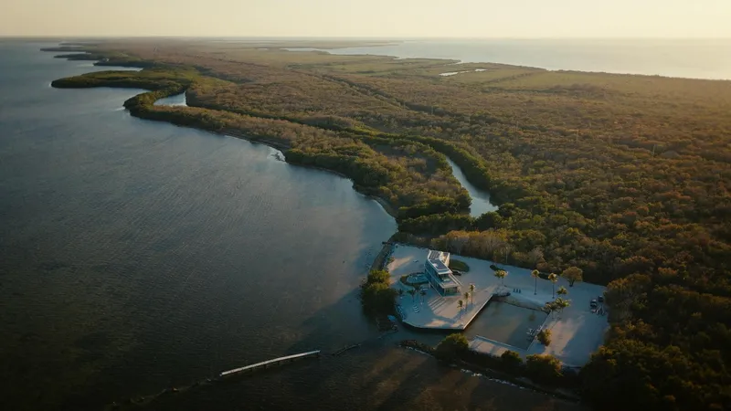 Aerial view of the residence on a private island surrounded by mangroves at golden hour