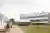 This architectural image showcases a modern industrial building with a distinctive sawtooth roof and