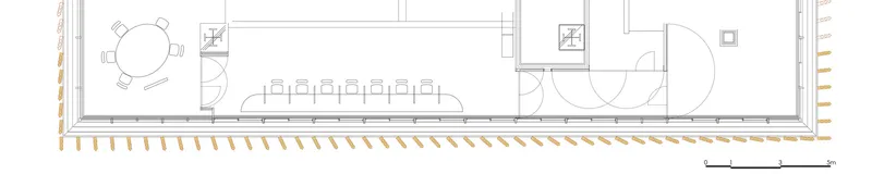 Floor plan drawing showing an elongated interior with round table, long dining table, and bathroom fixtures