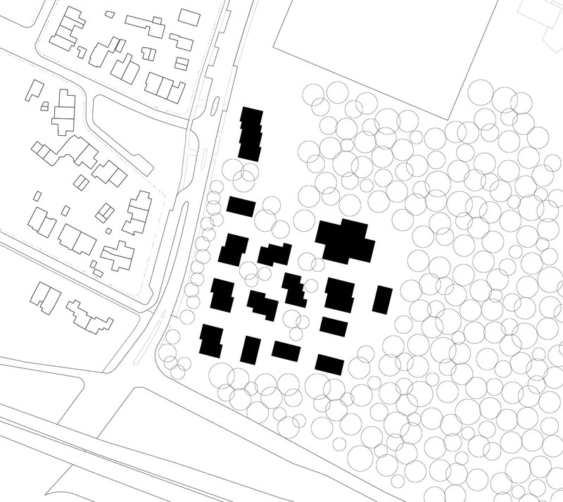 Site plan drawing showing cluster of solid buildings among tree canopies adjacent to open landscape