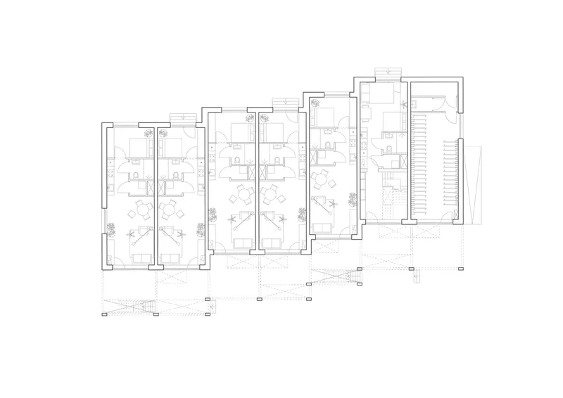 Floor plan drawing showing a row of four residential units with small planted areas at their entrances