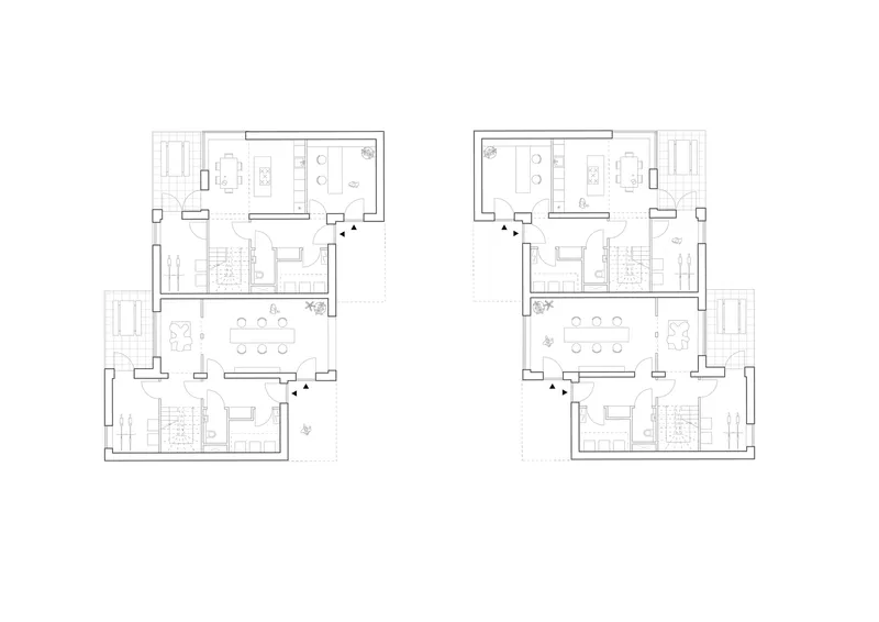 Floor plan drawing of two mirrored residential units with central staircases and balconies