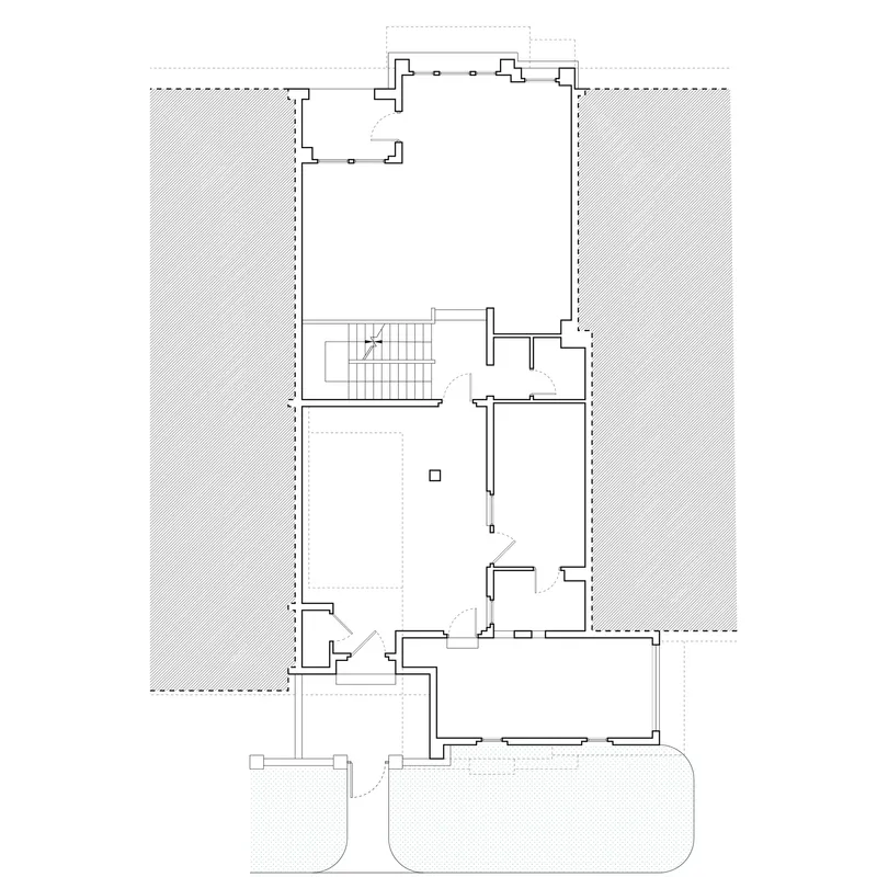Floor plan drawing showing a central staircase with adjacent rooms and outdoor terraces