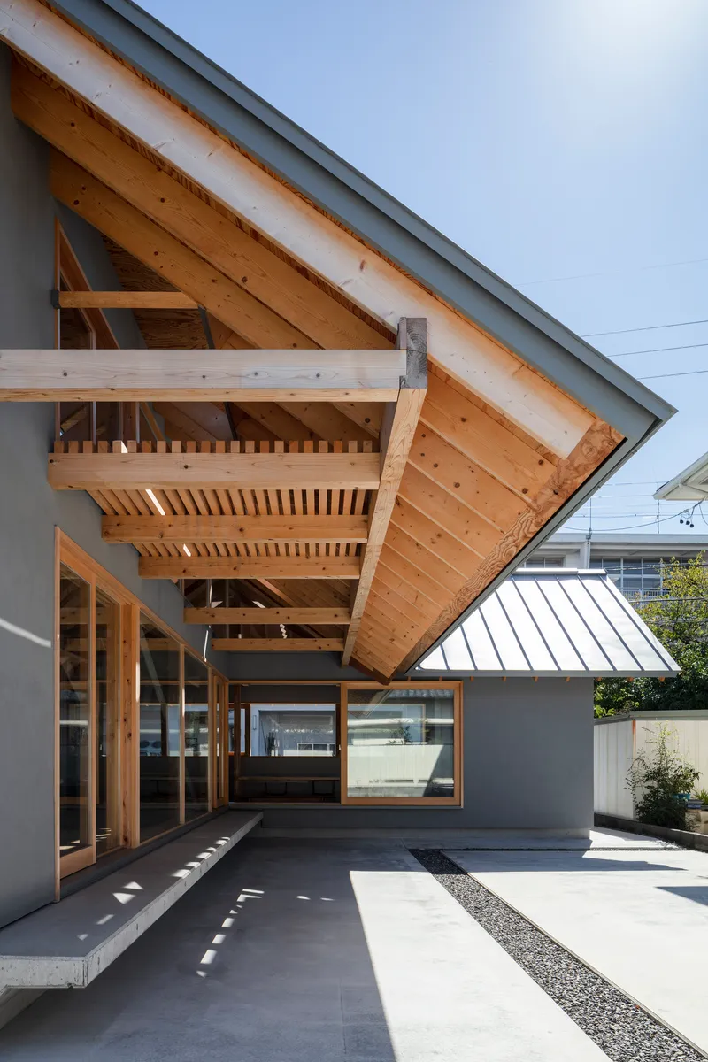Underside of the cantilevered timber roof eave showing exposed rafters and structural joinery