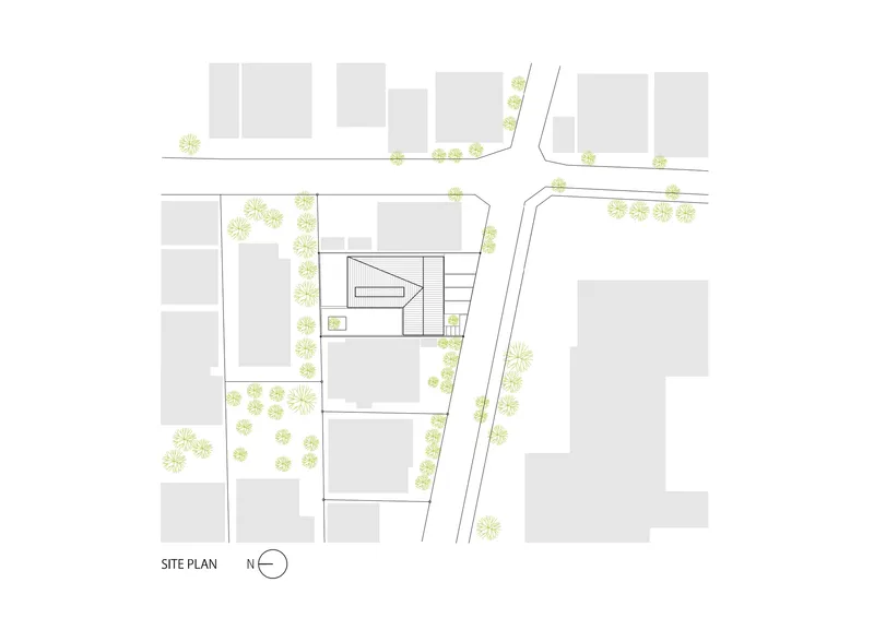 Site plan drawing showing the building footprint and surrounding street trees in the neighborhood context