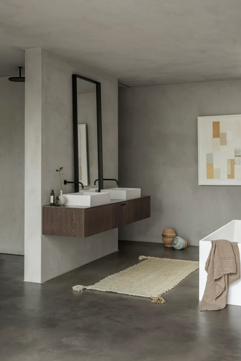 Bathroom with floating dark timber vanity and rectangular vessel sinks beneath a tall black-framed mirror