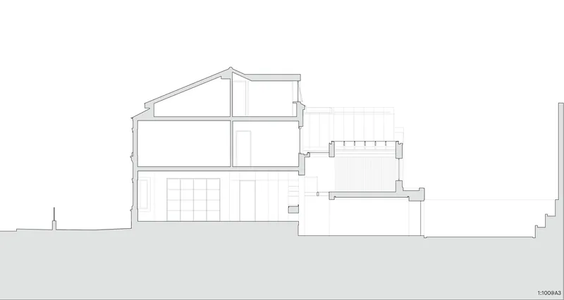 Section drawing showing a split-level house with pitched roof volumes and a lower adjoining block