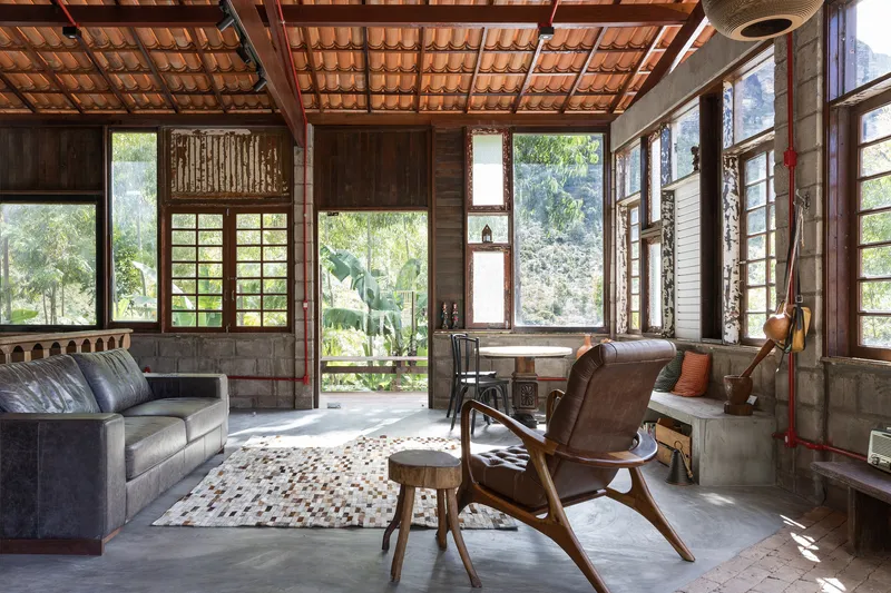 Interior view with terra-cotta tile ceiling, concrete base walls and framed openings filtering daylight