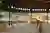 This architectural image showcases a modern pavilion in a village setting, designed as a community s