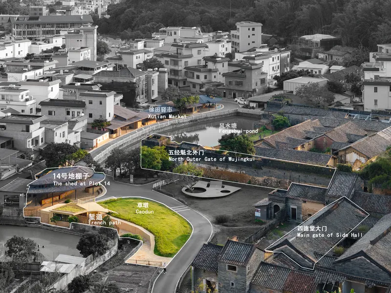Aerial view of illuminated timber structures nestled among traditional tile-roofed houses at dusk