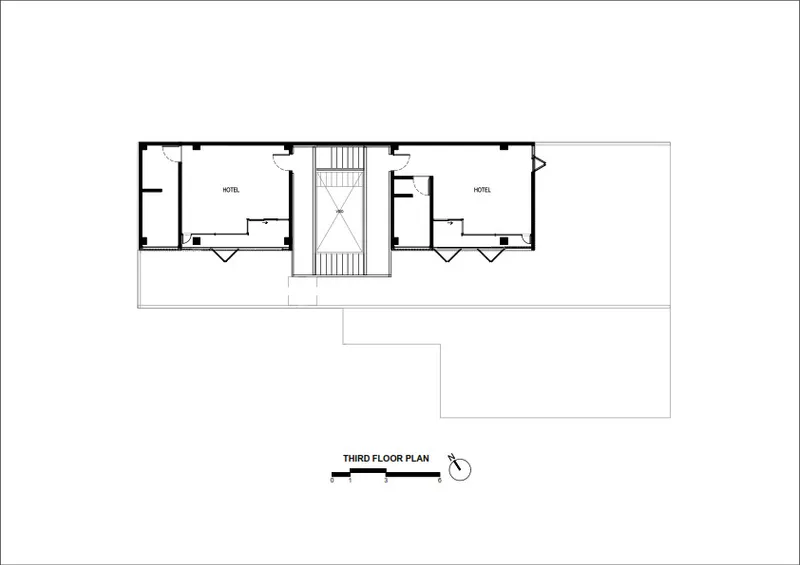 Third floor plan drawing showing two hotel rooms flanking a central stairwell