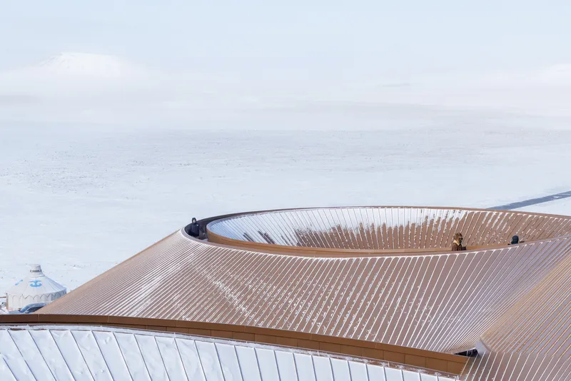 Rooftop close-up showing the radial timber roof structure with two skylights