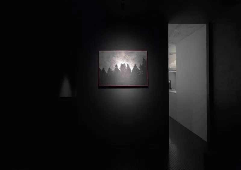 Gallery room with black walls and a single illuminated artwork beside an open doorway