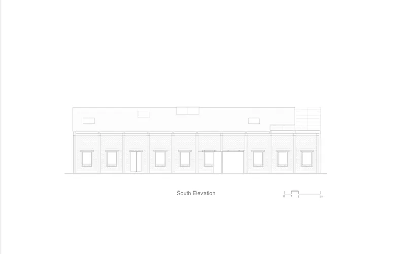 South elevation drawing showing a long single-story facade with patterned brickwork and regular window openings