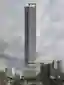 This architectural image showcases a tall, modern skyscraper with a distinctive grid-like facade. Th